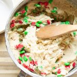cookie batter with red and green M&M candies